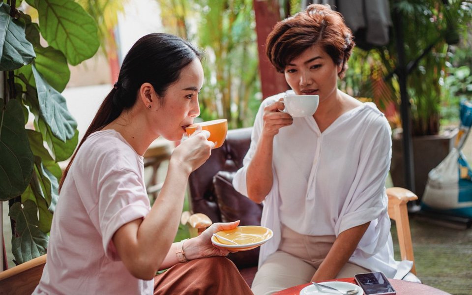 Two friends talking over tea
