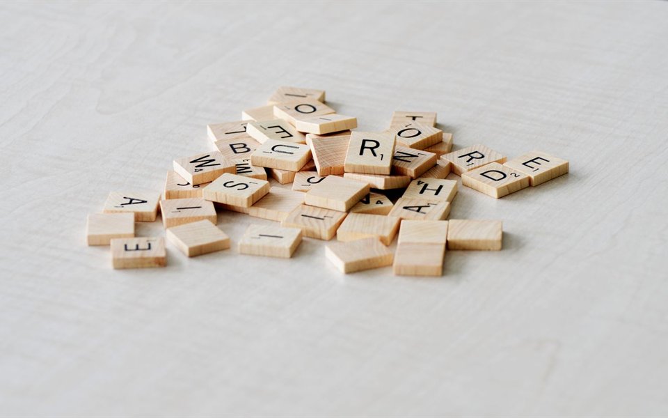 Wooden letter tiles scattered on a table